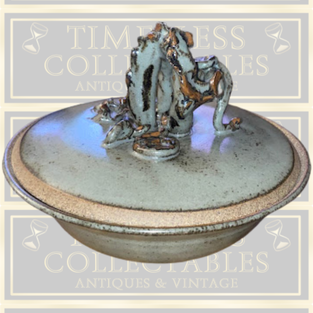 Stoneware Lidded Bowl Featuring a sculptural, animal-themed handle on the lid.