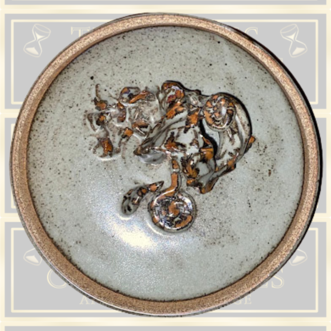 Stoneware Lidded Bowl Featuring a sculptural, animal-themed handle on the lid.