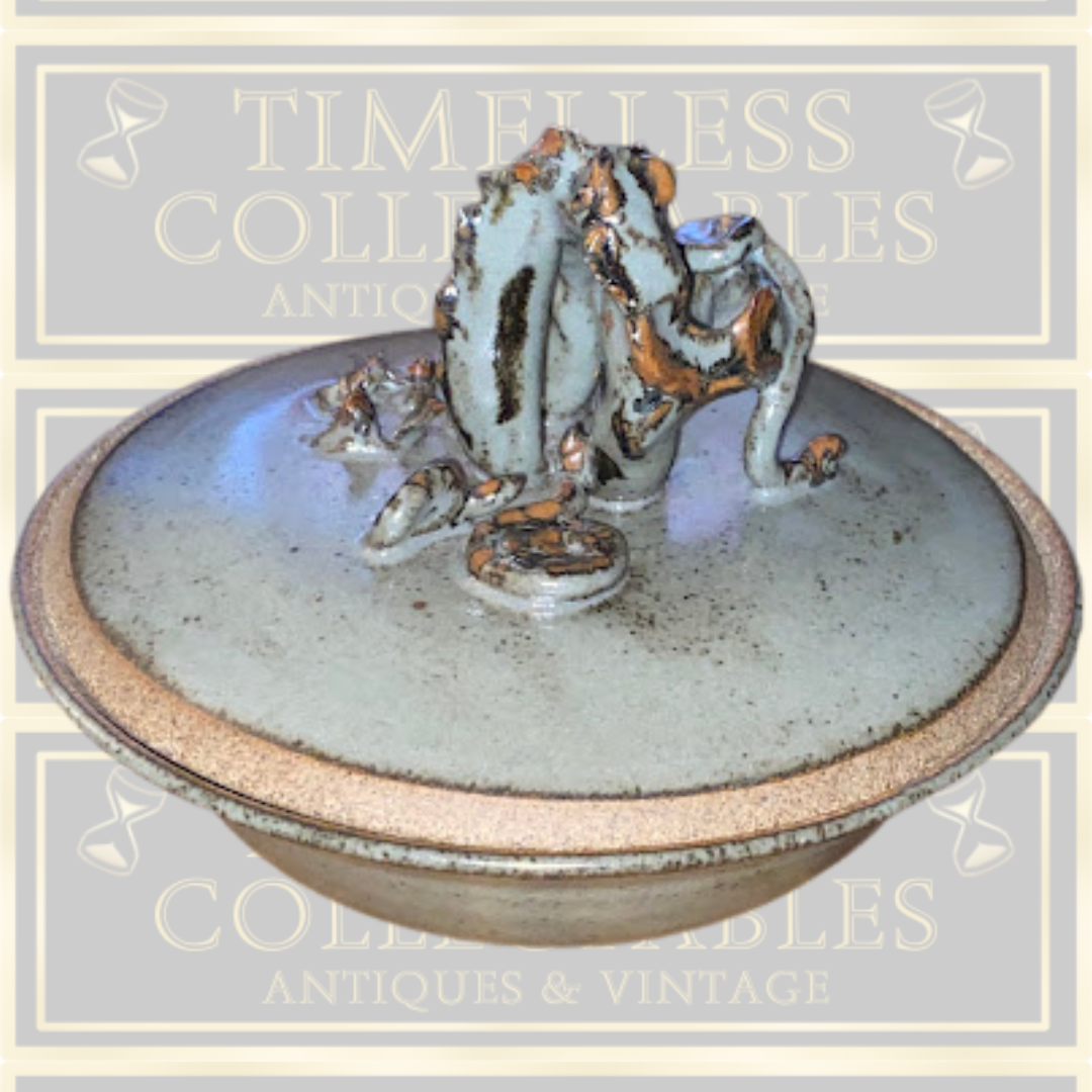 Stoneware Lidded Bowl Featuring a sculptural, animal-themed handle on the lid.