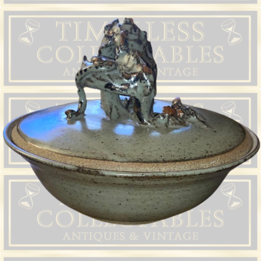 Stoneware Lidded Bowl Featuring a sculptural, animal-themed handle on the lid.