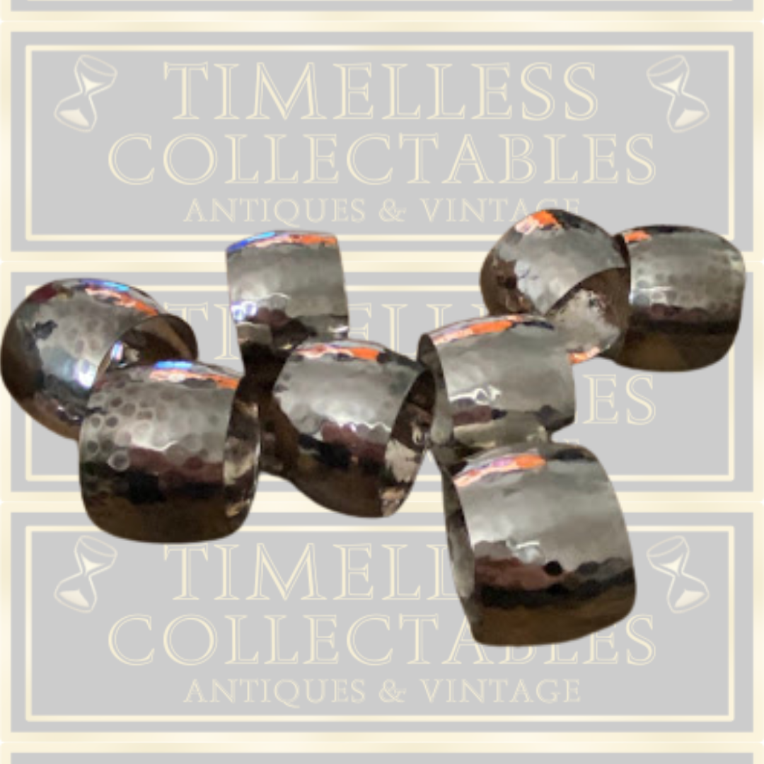 Eight Silver Toned Hammered Pattern Napkin Rings