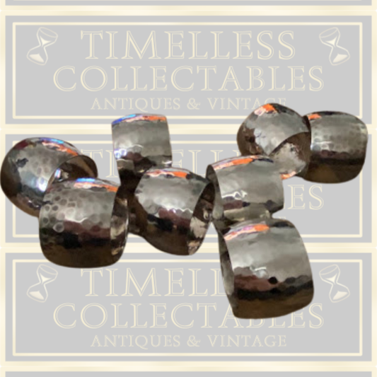 Eight Silver Toned Hammered Pattern Napkin Rings