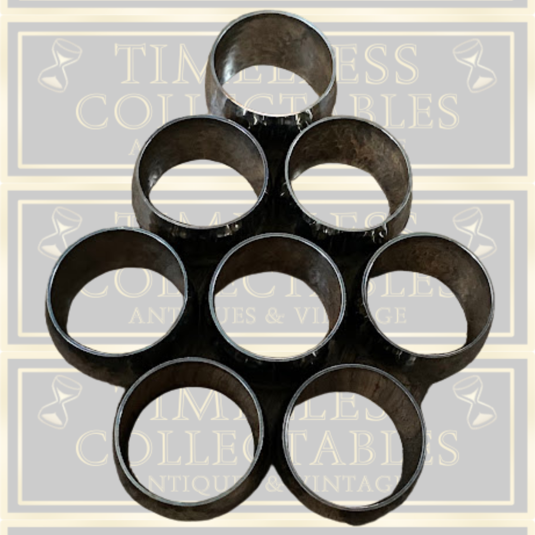 Eight Silver Toned Hammered Pattern Napkin Rings