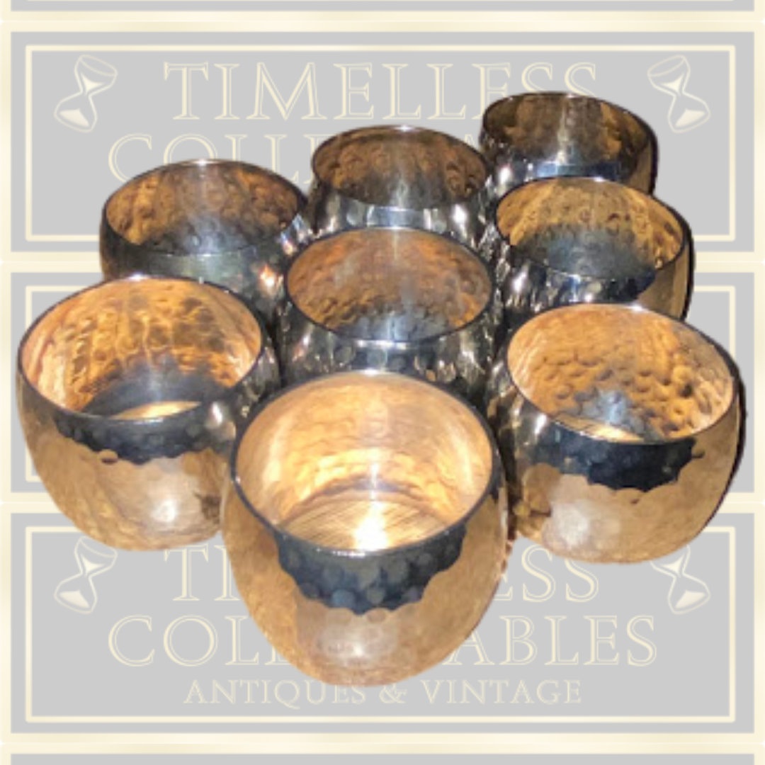 Eight Silver Toned Hammered Pattern Napkin Rings