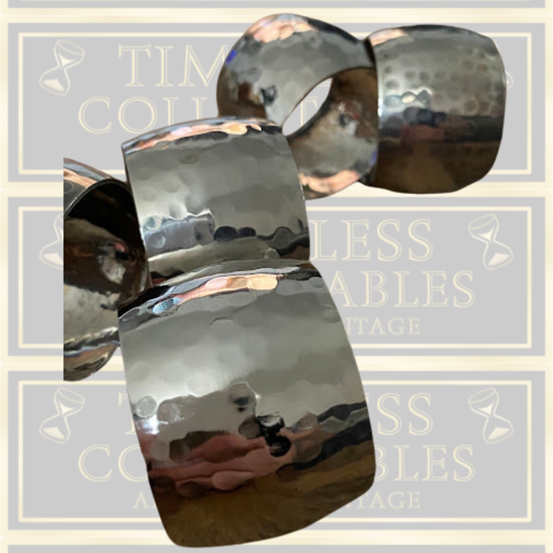 Eight Silver Toned Hammered Pattern Napkin Rings