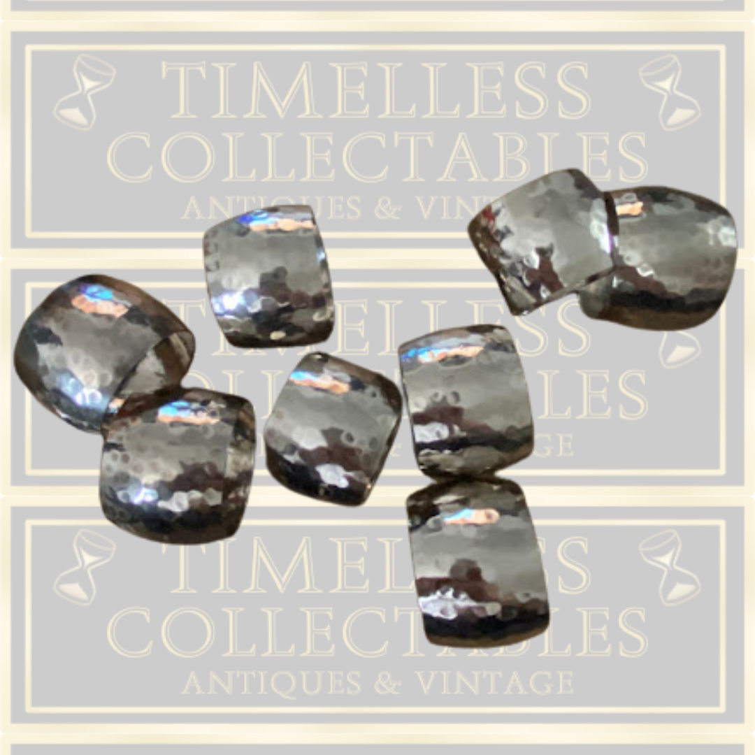 Eight Silver Toned Hammered Pattern Napkin Rings
