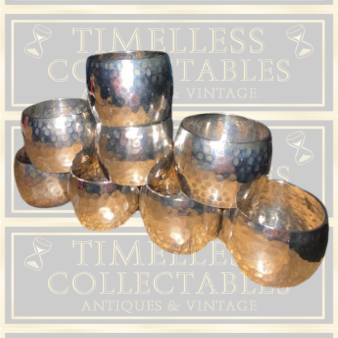Eight Silver Toned Hammered Pattern Napkin Rings